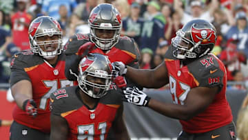 Nov 27, 2016; Tampa, FL, USA; Tampa Bay Buccaneers defensive end Robert Ayers (91) is congratulated after he sacks Seattle Seahawks quarterback Russell Wilson (3) during the first half at Raymond James Stadium. Mandatory Credit: Kim Klement-USA TODAY Sports