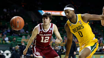 Jan 6, 2021; Waco, Texas, USA; Baylor Bears forward Flo Thamba (0) and Oklahoma Sooners guard Austin Reaves (12) watch the ball during the second half at Ferrell Center. Mandatory Credit: Kevin Jairaj-USA TODAY Sports