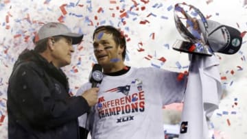 Jan 18, 2015; Foxborough, MA, USA; New England Patriots quarterback Tom Brady (right) holds up the Lamar Hunt Trophy as he is interviewed after the AFC Championship Game against the Indianapolis Colts at Gillette Stadium. Mandatory Credit: David Butler II-USA TODAY Sports