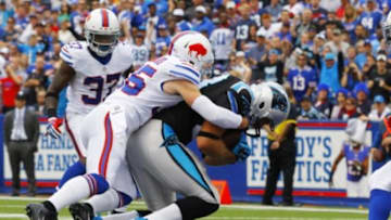 Sep 15, 2013; Orchard Park, NY, USA; Carolina Panthers tight end Greg Olsen (88) catches the ball while being defended by Buffalo Bills defensive back Jim Leonhard (35) for a first half touchdown against the Buffalo Bills at Ralph Wilson Stadium. Mandatory Credit: Timothy T. Ludwig-USA TODAY Sports