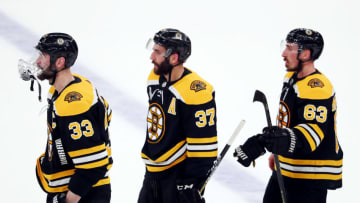 BOSTON, MASSACHUSETTS - JUNE 12: Zdeno Chara #33, Patrice Bergeron #37 and Brad Marchand #63 of the Boston Bruins await to shake the hands of the St. Louis Blues after losing Game Seven of the 2019 NHL Stanley Cup Final at TD Garden on June 12, 2019 in Boston, Massachusetts. (Photo by Adam Glanzman/Getty Images)