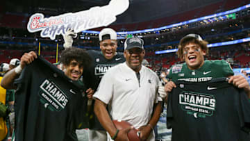 Dec 30, 2021; Atlanta, GA, USA; Michigan State Spartans running back Jordon Simmons (22) and offensive lineman Spencer Brown (58) and head coach Mel Tucker and tight end Connor Heyward (11) celebrate after a victory against the Pittsburgh Panthers in the 2021 Peach Bowl at Mercedes-Benz Stadium. Mandatory Credit: Brett Davis-USA TODAY Sports