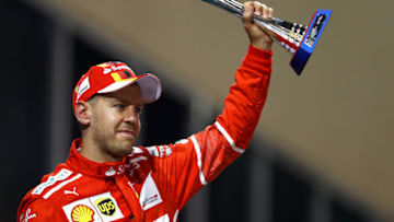 ABU DHABI, UNITED ARAB EMIRATES - NOVEMBER 26: Third place finisher Sebastian Vettel of Germany and Ferrari celebrates on the podium during the Abu Dhabi Formula One Grand Prix at Yas Marina Circuit on November 26, 2017 in Abu Dhabi, United Arab Emirates. (Photo by Dan Istitene/Getty Images)