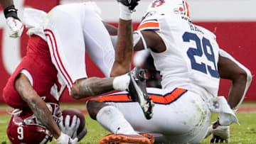 Auburn footballNov 28, 2020; Tuscaloosa, Alabama, USA; Alabama wide receiver DeVonta Smith (6) is put on his head by Auburn defensive lineman Derick Hall (29) at Bryant-Denny Stadium in the Iron Bowl. Mandatory Credit: Mickey Welsh/The Montgomery Advertiser via USA TODAY Sports