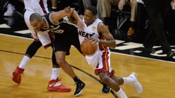 Jun 12, 2014; Miami, FL, USA; Miami Heat guard Mario Chalmers (15) works around the defense of San Antonio Spurs guard Tony Parker (9) during the first quarter of game four of the 2014 NBA Finals at American Airlines Arena. Mandatory Credit: Steve Mitchell-USA TODAY Sports