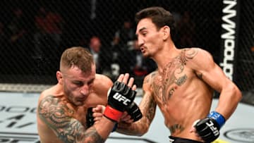Max Holloway punches Alexander Volkanovski (Photo by Jeff Bottari/Zuffa LLC via Getty Images)