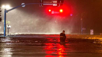 BILOXI,MS-OCTOBER 8, 2017: Lanny Dean, from Tulsa, Oklahoma, takes video as he wades along a flooded Beach Boulevard next to Harrahs Casino as the eye of Hurricane Nate pushes ashore in Biloxi, Mississippi October 8, 2017. Hurricane Nate flooded the parking garage and first floors of Golden Nugget, Harrahs and other casinos as it made a second landfall on the Mississippi coast as a category 1 storm. (Photo by Mark Wallheiser/Getty Images)