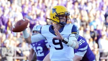 Oct 26, 2013; Manhattan, KS, USA; West Virginia Mountaineers quarterback Clint Trickett (9) attempts a pass against the Kansas State Wildcats during the second half at Bill Snyder Family Stadium. The Wildcats defeat the Mountaineers 35-12. Mandatory Credit: Jasen Vinlove-USA TODAY Sports