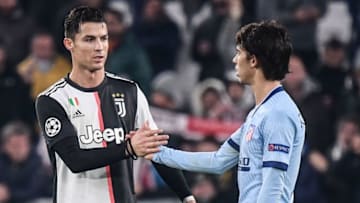 Juventus' Portuguese forward Cristiano Ronaldo (L) taps hands with Atletico Madrid's Portuguese forward Joao Felix (Photo by Marco Bertorello / AFP) (Photo by MARCO BERTORELLO/AFP via Getty Images)
