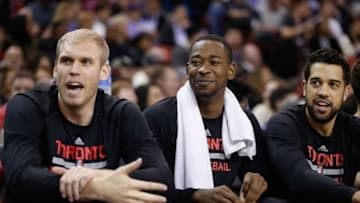 Dec 2, 2014; Sacramento, CA, USA; Toronto Raptors center Greg Stiemsma (34), forward Terrence Ross (31) and guard Landry Fields (2) engage in conversation with a court side Sacramento Kings fan during the third quarter at Sleep Train Arena. The Raptors won 117-109. Mandatory Credit: Kelley L Cox-USA TODAY Sports