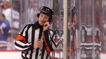 GLENDALE, AZ - DECEMBER 17: Referre Tim Peel talks with NHL officials in Toronto as they review Brad Richards #19 of the New York Rangers goal in the final second during the NHL game against the Phoenix Coyotes at Jobing.com Arena on December 17, 2011 in Glendale, Arizona. The Rangers defeated the Coyotes 3-2. (Photo by Christian Petersen/Getty Images)