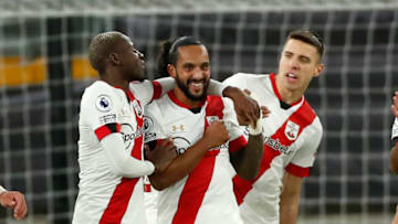 Southampton's English midfielder Theo Walcott (C) celebrates with teammates after scoring the opening goal of the English Premier League football match between Wolverhampton Wanderers and Southampton at the Molineux stadium in Wolverhampton, central England on November 23, 2020. (Photo by ANDREW BOYERS / POOL / AFP) / RESTRICTED TO EDITORIAL USE. No use with unauthorized audio, video, data, fixture lists, club/league logos or 'live' services. Online in-match use limited to 120 images. An additional 40 images may be used in extra time. No video emulation. Social media in-match use limited to 120 images. An additional 40 images may be used in extra time. No use in betting publications, games or single club/league/player publications. / (Photo by ANDREW BOYERS/POOL/AFP via Getty Images)
