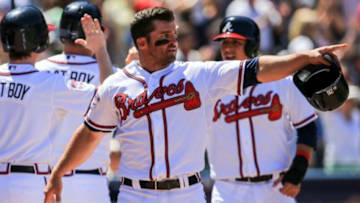 Apr 23, 2014; Atlanta, GA, USA; Atlanta Braves second baseman Dan Uggla (26) points to catcher Evan Gattis (24) after scoring in the eighth inning against the Miami Marlins at Turner Field. Mandatory Credit: Daniel Shirey-USA TODAY Sports