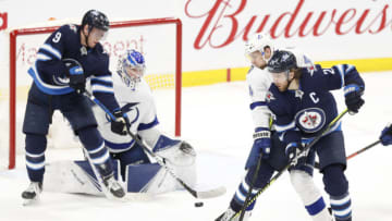 Jan 17, 2020; Winnipeg, Manitoba, CAN; Winnipeg Jets right wing Blake Wheeler (26) and Tampa Bay Lightning defenseman Jan Rutta (44) tangle up in front of Tampa Bay Lightning goaltender Andrei Vasilevskiy (88) in the third period at Bell MTS Place. Mandatory Credit: James Carey Lauder-USA TODAY Sports
