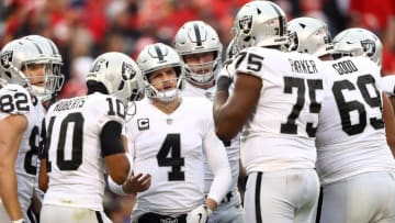KANSAS CITY, MISSOURI - DECEMBER 30: Quarterback Derek Carr #4 of the Oakland Raiders huddles with teammates during the game against the Kansas City Chiefs at Arrowhead Stadium on December 30, 2018 in Kansas City, Missouri. (Photo by Jamie Squire/Getty Images)
