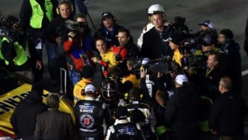 Feb 14, 2015; Daytona Beach, FL, USA; NASCAR Sprint Cup Series drivers Joey Logano (22) and Kevin Harvick (4) fight after the Sprint Unlimited at Daytona International Speedway. Mandatory Credit: Andrew Weber-USA TODAY Sports