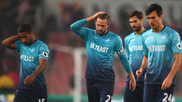STOKE ON TRENT, ENGLAND - OCTOBER 31: Wayne Routledge (15), Gylfi Sigurdsson (23) and Jack Cork of Swansea City (24) look dejected in defeat after the Premier League match between Stoke City and Swansea City at Bet365 Stadium on October 31, 2016 in Stoke on Trent, England. (Photo by Laurence Griffiths/Getty Images)