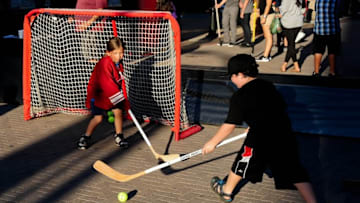 Oct 9, 2014; Glendale, AZ, USA; Young fans play street hockey prior to the game between the Arizona Coyotes and the Winnipeg Jets at Gila River Arena. Mandatory Credit: Matt Kartozian-USA TODAY Sports
