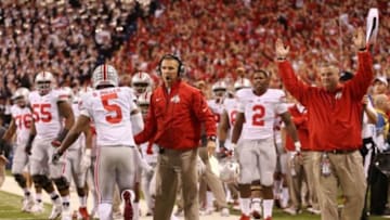 Dec 7, 2013; Indianapolis, IN, USA; Ohio State Buckeyes quarterback Braxton Miller (5) after scoring a touchdown is congratulated by coach Urban Meyer against the Michigan State Spartans during the Big Ten Championship game at Lucas Oil Stadium. Mandatory Credit: Brian Spurlock-USA TODAY Sports