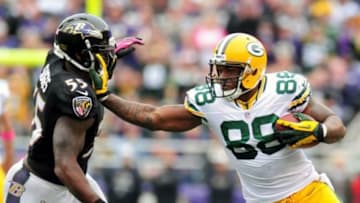 Oct 13, 2013; Baltimore, MD, USA; Green Bay Packers tight end Jermichael Finley (88) stiff arms Baltimore Ravens linebacker Terrell Suggs (55) at M&T Bank Stadium. Mandatory Credit: Evan Habeeb-USA TODAY Sports