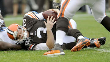 Oct 13, 2013; Cleveland, OH, USA; Cleveland Browns quarterback Brandon Weeden (3) is sacked by Detroit Lions defensive end Willie Young (79) during the third quarter at FirstEnergy Stadium. The Lions beat the Browns 31-17. Mandatory Credit: Ken Blaze-USA TODAY Sports