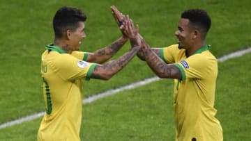 TOPSHOT - Brazil's Roberto Firmino (L) celebrates with Brazil's Gabriel Jesus after scoring against Argentina during their Copa America football tournament semi-final match at the Mineirao Stadium in Belo Horizonte, Brazil, on July 2, 2019. (Photo by MAURO PIMENTEL / AFP) (Photo credit should read MAURO PIMENTEL/AFP/Getty Images)