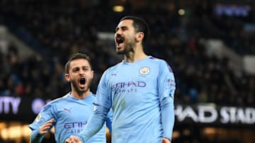 MANCHESTER, ENGLAND - DECEMBER 21: Ilkay Gundogan of Manchester City celebrates with teammate Bernardo Silva after scoring his team's second goal during the Premier League match between Manchester City and Leicester City at Etihad Stadium on December 21, 2019 in Manchester, United Kingdom. (Photo by Michael Regan/Getty Images)