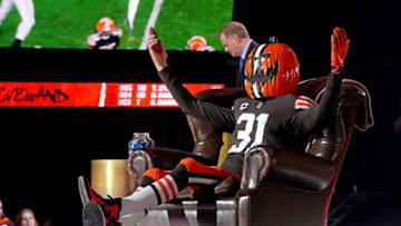 Apr 29, 2021; Cleveland, Ohio, USA; A Cleveland Browns fan in a pumpkin head sits on the commissioners chair during the 2021 NFL Draft at First Energy Stadium. Mandatory Credit: Kirby Lee-USA TODAY Sports