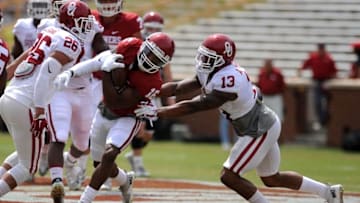 Apr 9, 2016; Norman, OK, USA; Oklahoma Sooners wide receiver Miciah Quick (16) is tackled by linebacker Jordan Evans (26) and defensive back AD Miller (13) during the first half of the spring game at Oklahoma Memorial Stadium. Mandatory Credit: Mark D. Smith-USA TODAY Sports