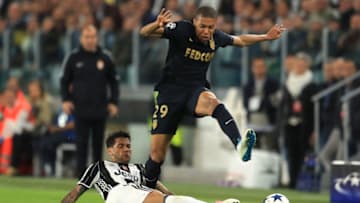 TURIN, ITALY - MAY 09: Dani Alves of Juventus tackles Kylian Mbappe of AS Monaco during the UEFA Champions League Semi Final second leg match between Juventus and AS Monaco at Juventus Stadium on May 9, 2017 in Turin, Italy. (Photo by Richard Heathcote/Getty Images)