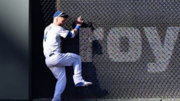 Oct 15, 2014; Kansas City, MO, USA; Kansas City Royals left fielder Alex Gordon crashes into the wall after catching a fly ball hit by Baltimore Orioles shortstop J.J. Hardy (not pictured) during the fifth inning in game four of the 2014 ALCS playoff baseball game at Kauffman Stadium. Mandatory Credit: Peter G. Aiken-USA TODAY Sports