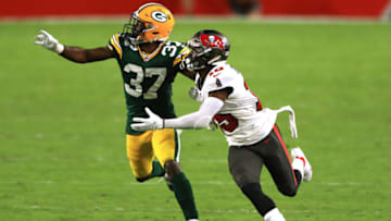 TAMPA, FLORIDA - OCTOBER 18: Josh Jackson #37 of the Green Bay Packers and Cyril Grayson #15 of the Tampa Bay Buccaneers go after a pass during the fourth quarter at Raymond James Stadium on October 18, 2020 in Tampa, Florida. (Photo by Mike Ehrmann/Getty Images)