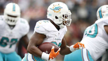 Sep 18, 2016; Foxborough, MA, USA; Miami Dolphins running back Kenyan Drake (32) carries the ball during the fourth quarter against the New England Patriots at Gillette Stadium. The New England Patriots won 31-24. Mandatory Credit: Greg M. Cooper-USA TODAY Sports