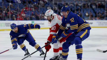 Nov 6, 2021; Buffalo, New York, USA; Detroit Red Wings center Joe Veleno (90) tries to take a shot on goal as Buffalo Sabres right wing Tage Thompson (72) knocks the puck off his stick during the first period at KeyBank Center. Mandatory Credit: Timothy T. Ludwig-USA TODAY Sports