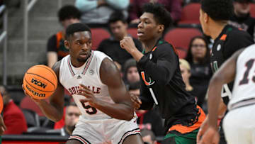 Dec 4, 2022; Louisville, Kentucky, USA; Louisville Cardinals forward Brandon Huntley-Hatfield (5) posts up against Miami (Fl) Hurricanes forward Anthony Walker (1) during the first half at KFC Yum! Center. Mandatory Credit: Jamie Rhodes-USA TODAY Sports