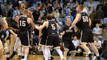 CHAPEL HILL, NC - DECEMBER 20: Players of the Wofford Terriers celebrate following their win against the North Carolina Tar Heels at Dean Smith Center on December 20, 2017 in Chapel Hill, North Carolina. Wofford won 79-75. (Photo by Lance King/Getty Images)