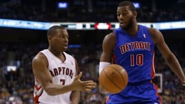 Mar 12, 2014; Toronto, Ontario, CAN; Toronto Raptors guard Kyle Lowry (7) passes the ball past Detroit Pistons forward-center Greg Monroe (10) during the first half at the Air Canada Centre. Mandatory Credit: John E. Sokolowski-USA TODAY Sports