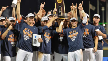 Omaha, NE - JUNE 24: Players and coaches of the Virginia Cavaliers hold up the National Championship trophy after defeating the Vanderbilt Commodores during game three of the College World Series Championship Series on June 24, 2015 at TD Ameritrade Park in Omaha, Nebraska. (Photo by Peter Aiken/Getty Images)
