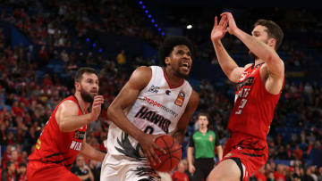 PERTH, AUSTRALIA - JUNE 14: Justin Simon of the Hawks drives to the basket against Mitchell Norton and Jarred Bairstow of the Wildcats during game three of the NBL Semi-Final Series between the Perth Wildcats and the Illawarra Hawks at RAC Arena, on June 14, 2021, in Perth, Australia. (Photo by Paul Kane/Getty Images)