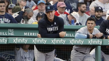 Aaron Judge #99 of the New York Yankees looks on from the dugout with Anthony Volpe #11 during the seventh inning of game one of a doubleheader against the Boston Red Sox at Fenway Park on June 18, 2023 in Boston, Massachusetts. (Photo By Winslow Townson/Getty Images)