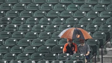 BALTIMORE, MD - SEPTEMBER 14: Fans watch the game in the rain between the Baltimore Orioles and the Chicago White Sox in the sixth inning against the at Oriole Park at Camden Yards on September 14, 2018 in Baltimore, Maryland. (Photo by Greg Fiume/Getty Images)