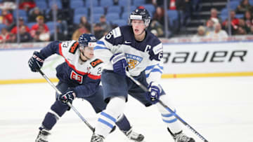BUFFALO, NY - DECEMBER 30: Juuso Välimäki #6 of Finland skates the puck up ice with Samuel Solenský #23 of Slovakia applying pressure during the second period of play in the IIHF World Junior Championships at the KeyBank Center on December 30, 2017 in Buffalo, New York. (Photo by Nicholas T. LoVerde/Getty Images) *** Samuel Solenský; Juuso Välimäki