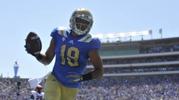 September 5, 2015; Pasadena, CA, USA; UCLA Bruins wide receiver Thomas Duarte (18) runs in to score a touch down against the Virginia Cavaliers during the first half at the Rose Bowl. Mandatory Credit: Gary A. Vasquez-USA TODAY Sports