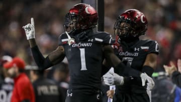 Nov 20, 2021; Cincinnati, Ohio, USA; Cincinnati Bearcats cornerback Ahmad Gardner (1) and cornerback Coby Bryant (7) react after cornerback Arquon Bush (not pictured) blocked a field goal by the Southern Methodist Mustangs in the second half at Nippert Stadium. Mandatory Credit: Katie Stratman-USA TODAY Sports