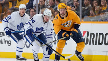 NASHVILLE, TN - MARCH 19: Auston Matthews #34 of the Toronto Maple Leafs battles for the puck against Filip Forsberg #9 of the Nashville Predators at Bridgestone Arena on March 19, 2019 in Nashville, Tennessee. (Photo by John Russell/NHLI via Getty Images)
