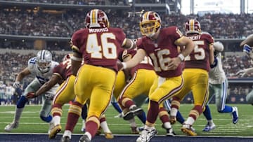 Jan 3, 2016; Arlington, TX, USA; Washington Redskins quarterback Colt McCoy (16) hands off to running back Alfred Morris (46) during the second half against the Dallas Cowboys at AT&T Stadium. The Redskins defeat the Cowboys 34-23. Mandatory Credit: Jerome Miron-USA TODAY Sports