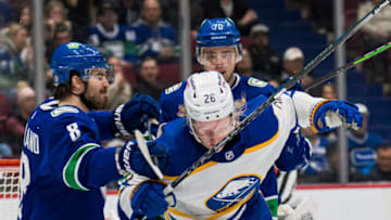 Mar 20, 2022; Vancouver, British Columbia, CAN; Vancouver Canucks forward Conor Garland (8) and forward Tanner Pearson (70) check Buffalo Sabres defenseman Rasmus Dahlin (26) in the second period at Rogers Arena. Mandatory Credit: Bob Frid-USA TODAY Sports