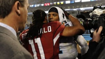 Jan 3, 2015; Charlotte, NC, USA; Arizona Cardinals wide receiver Larry Fitzgerald (11) greets Carolina Panthers quarterback Cam Newton (1) after the 2014 NFC Wild Card playoff football game at Bank of America Stadium. Mandatory Credit: Sam Sharpe-USA TODAY Sports