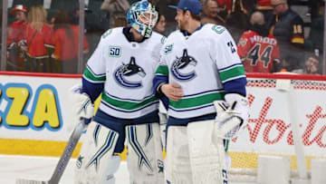 CALGARY, AB - DECEMBER 29: Jacob Markstrom #25 of the Vancouver Canucks congratulates teammate Thatcher Demko #35 on a win against the Calgary Flames at Scotiabank Saddledome on December 29, 2019 in Calgary, Alberta, Canada. (Photo by Gerry Thomas/NHLI via Getty Images)