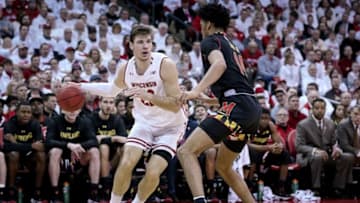 MADISON, WISCONSIN - FEBRUARY 01: Ethan Happ #22 of the Wisconsin Badgers dribbles the ball while being guarded by Ricky Lindo Jr. #14 of the Maryland Terrapins in the first half at the Kohl Center on February 01, 2019 in Madison, Wisconsin. (Photo by Dylan Buell/Getty Images)